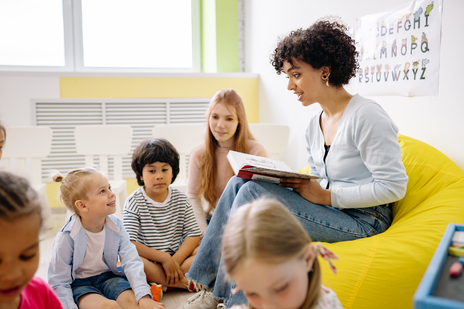 A teacher leading a guided reading session with her class