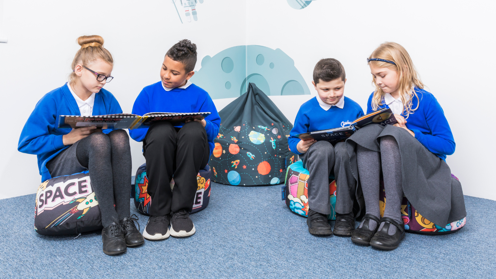 Primary curriculum pupils taking time to read together at school. 